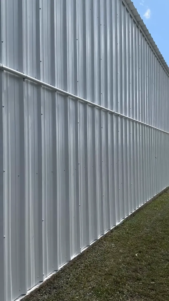 Long white metal building wall after painting