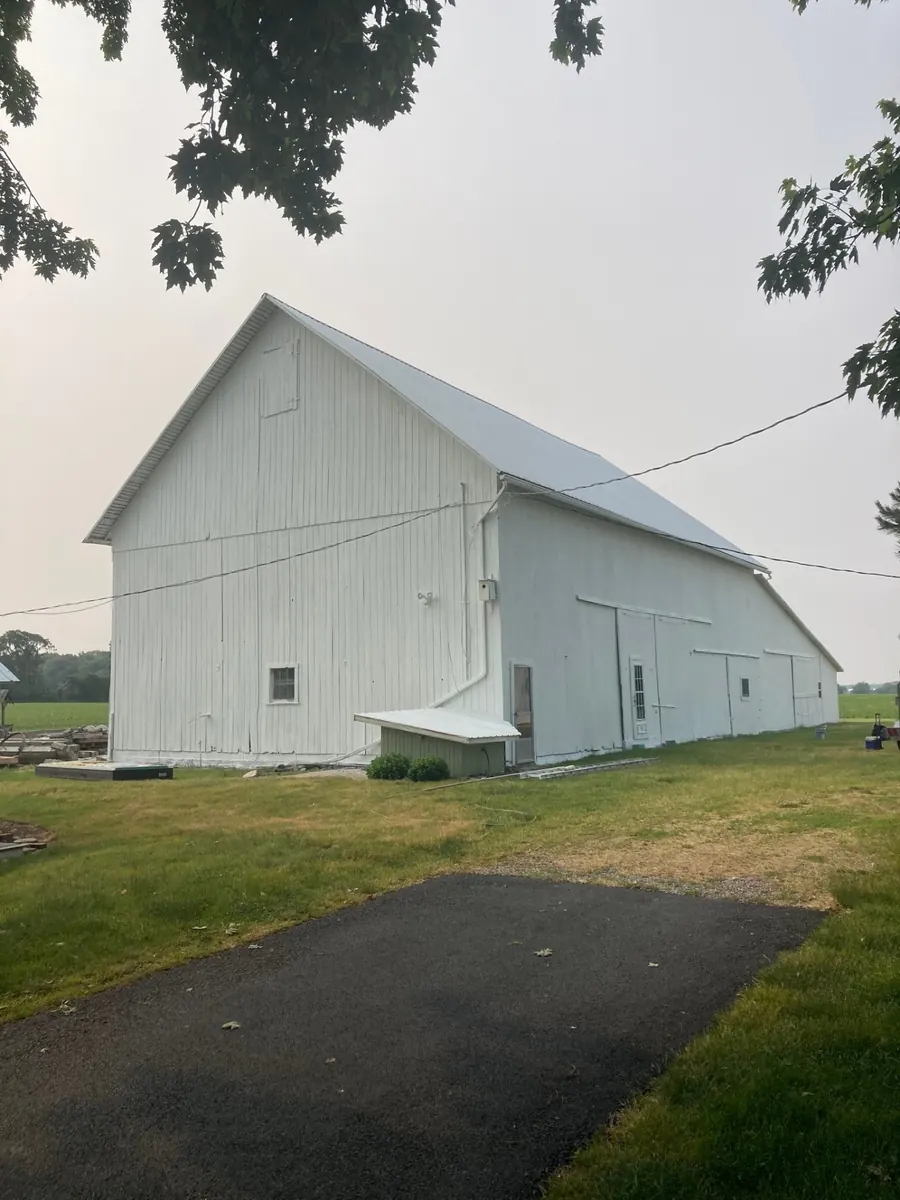 Large barn with clean white walls after painting